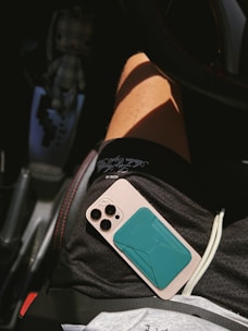 A person sitting in a car holding a cell phone