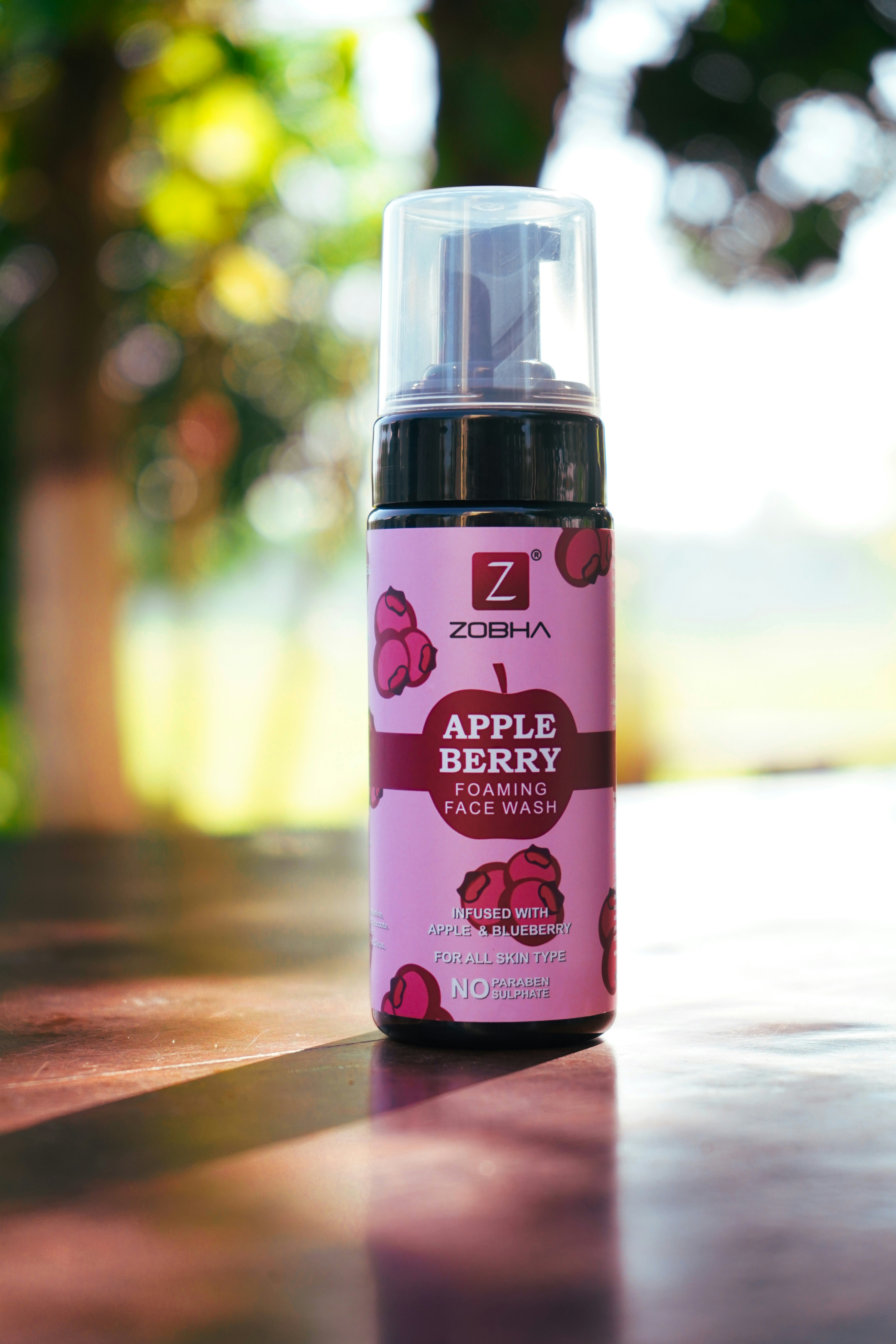 A bottle of apple berry deodorant sitting on a table