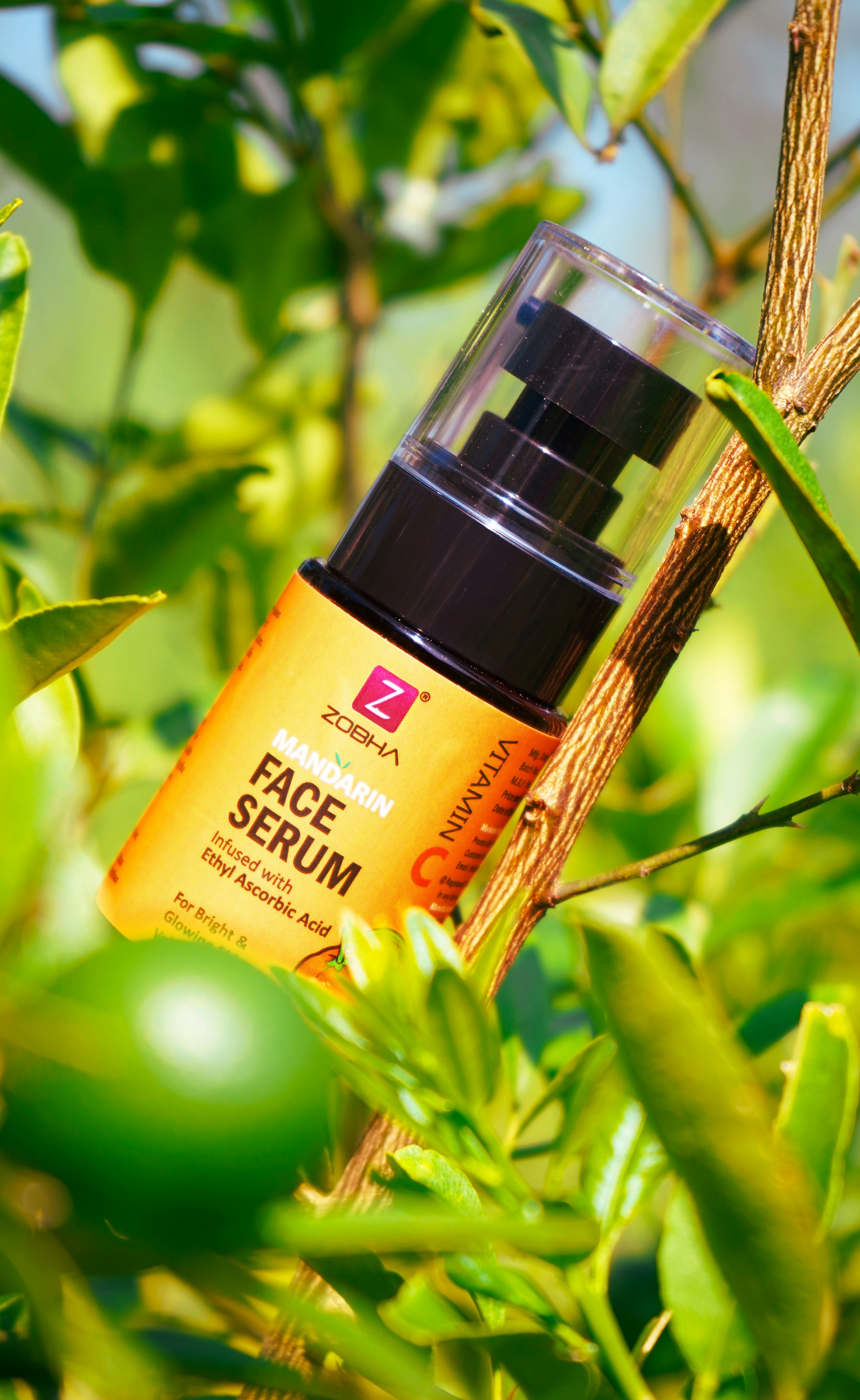 A close up of a bottle of face serum on a tree