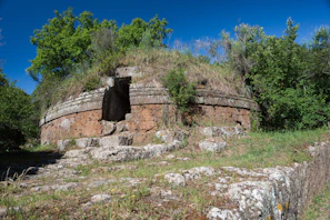 A stone structure with a door in the middle of it