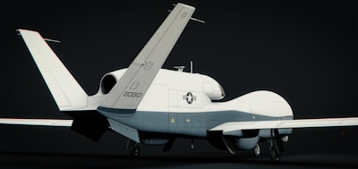 A white and blue plane is on a black background