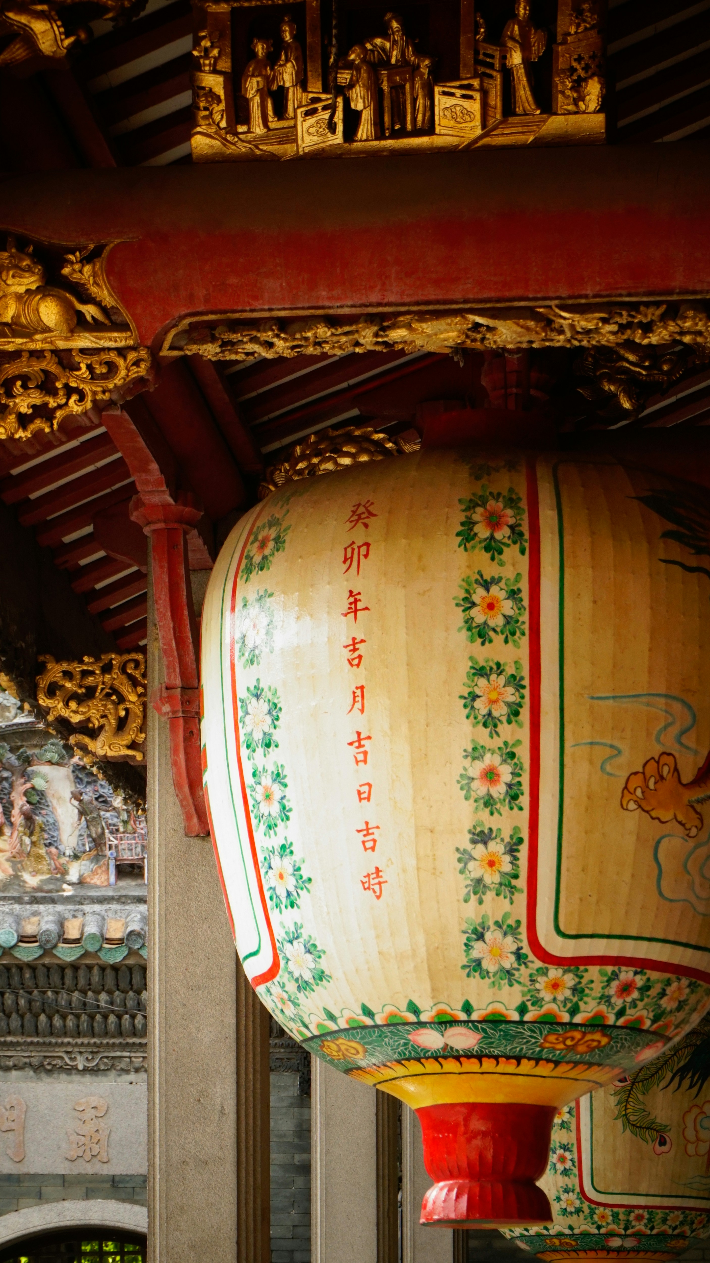A large lantern hanging from the ceiling of a building