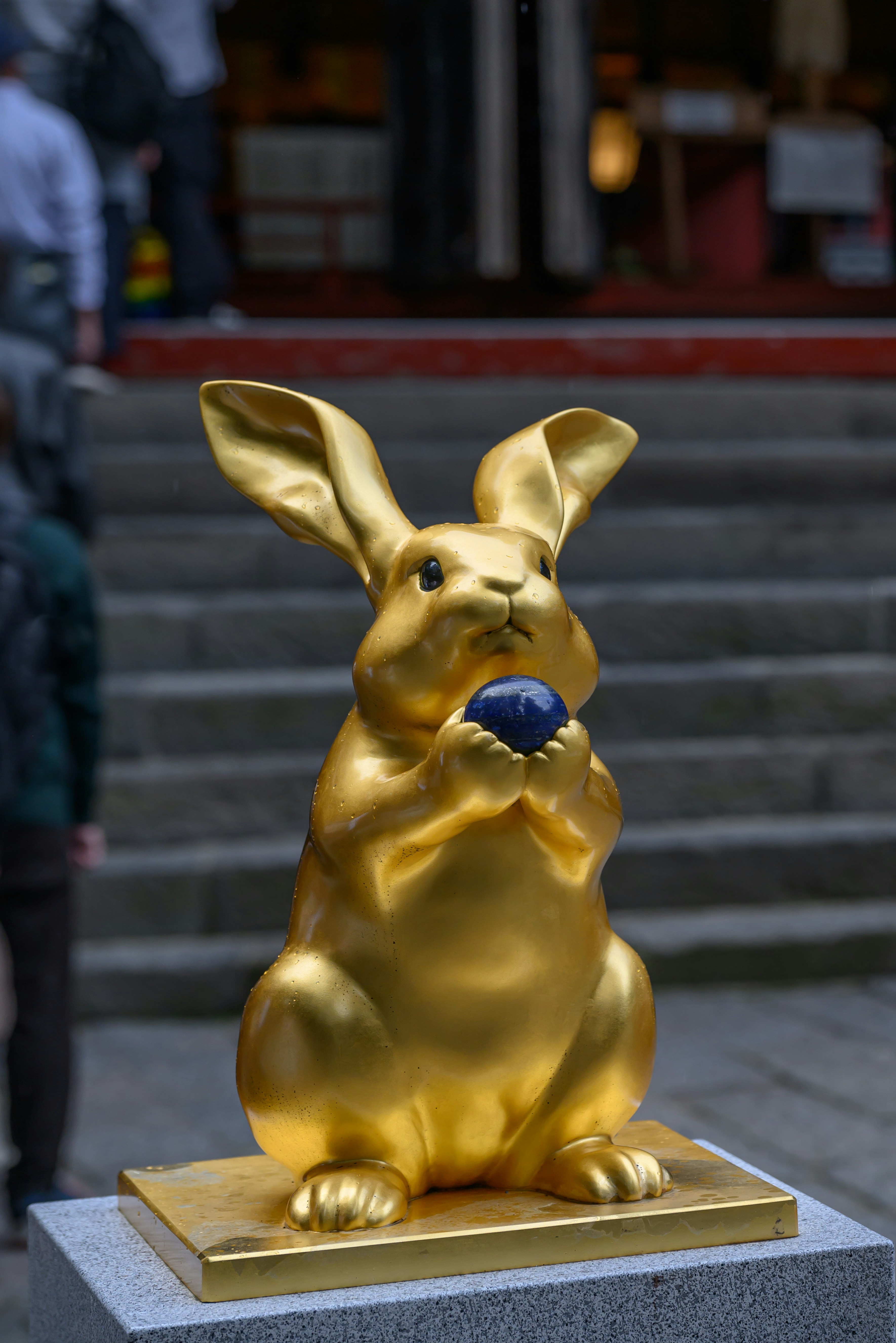 A golden statue of a rabbit on a pedestal