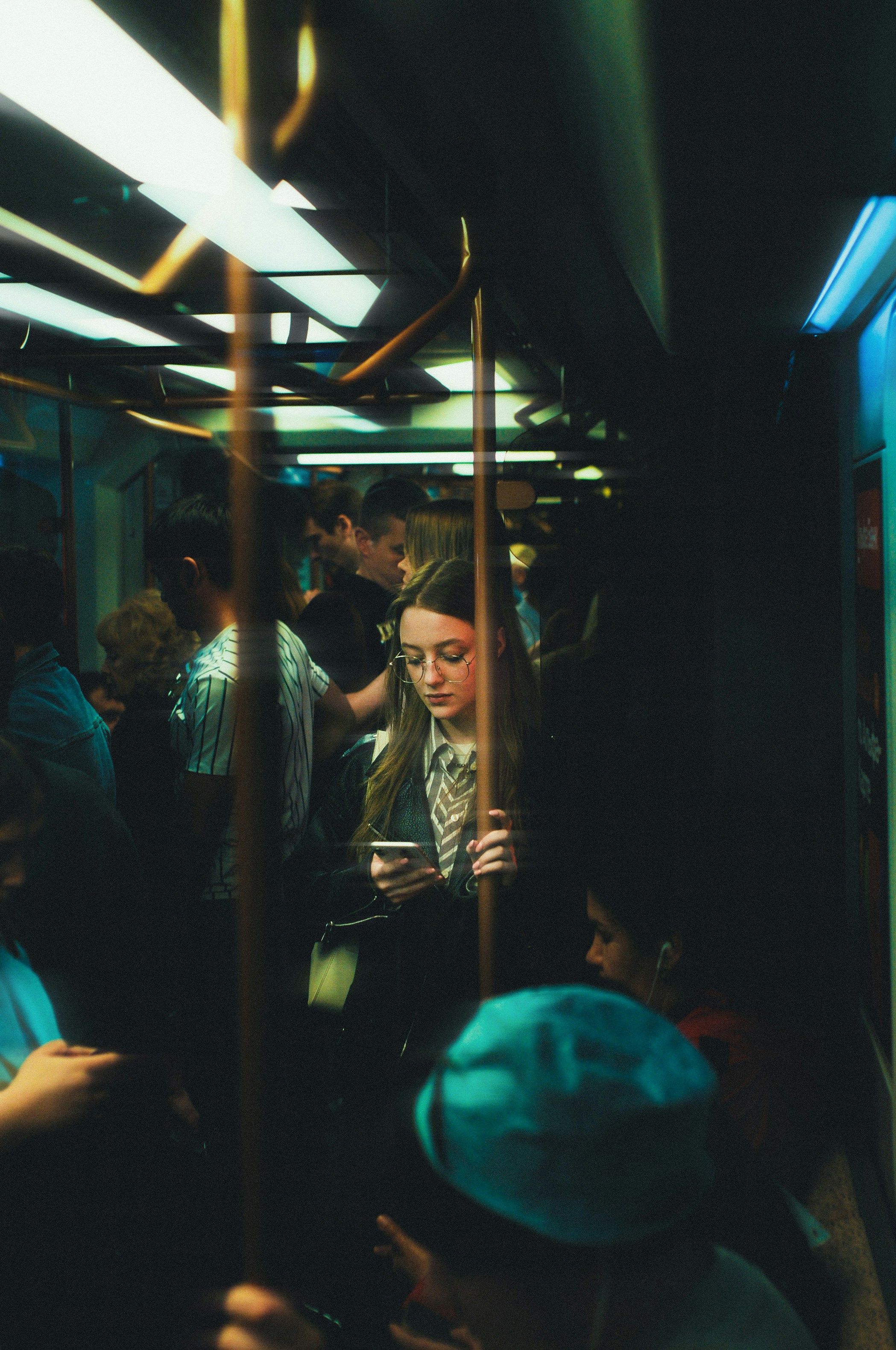 A group of people riding on a subway train