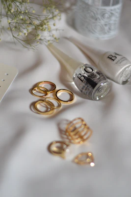 A table topped with gold rings and other items