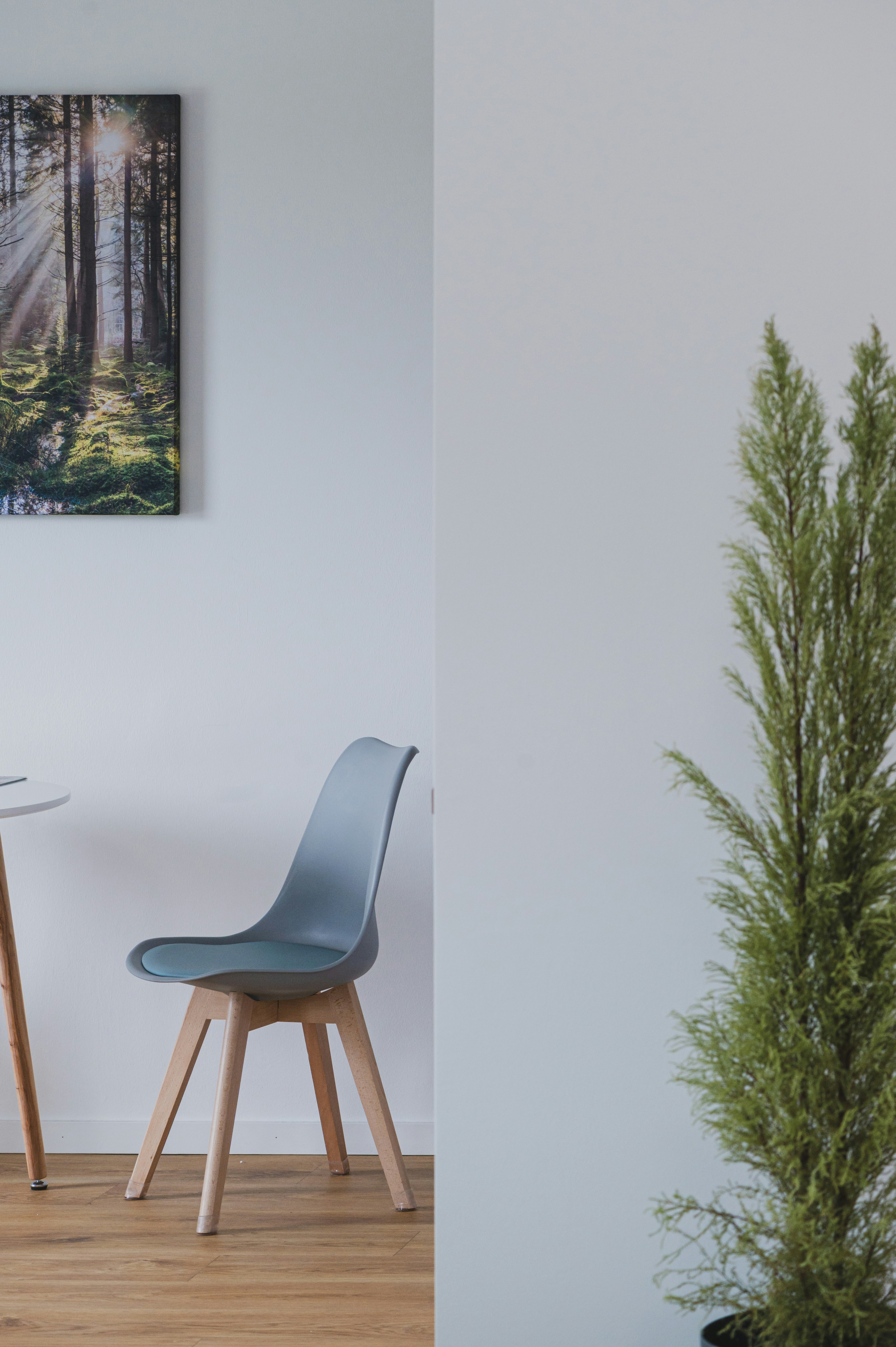 A table and chairs in a room with a painting on the wall