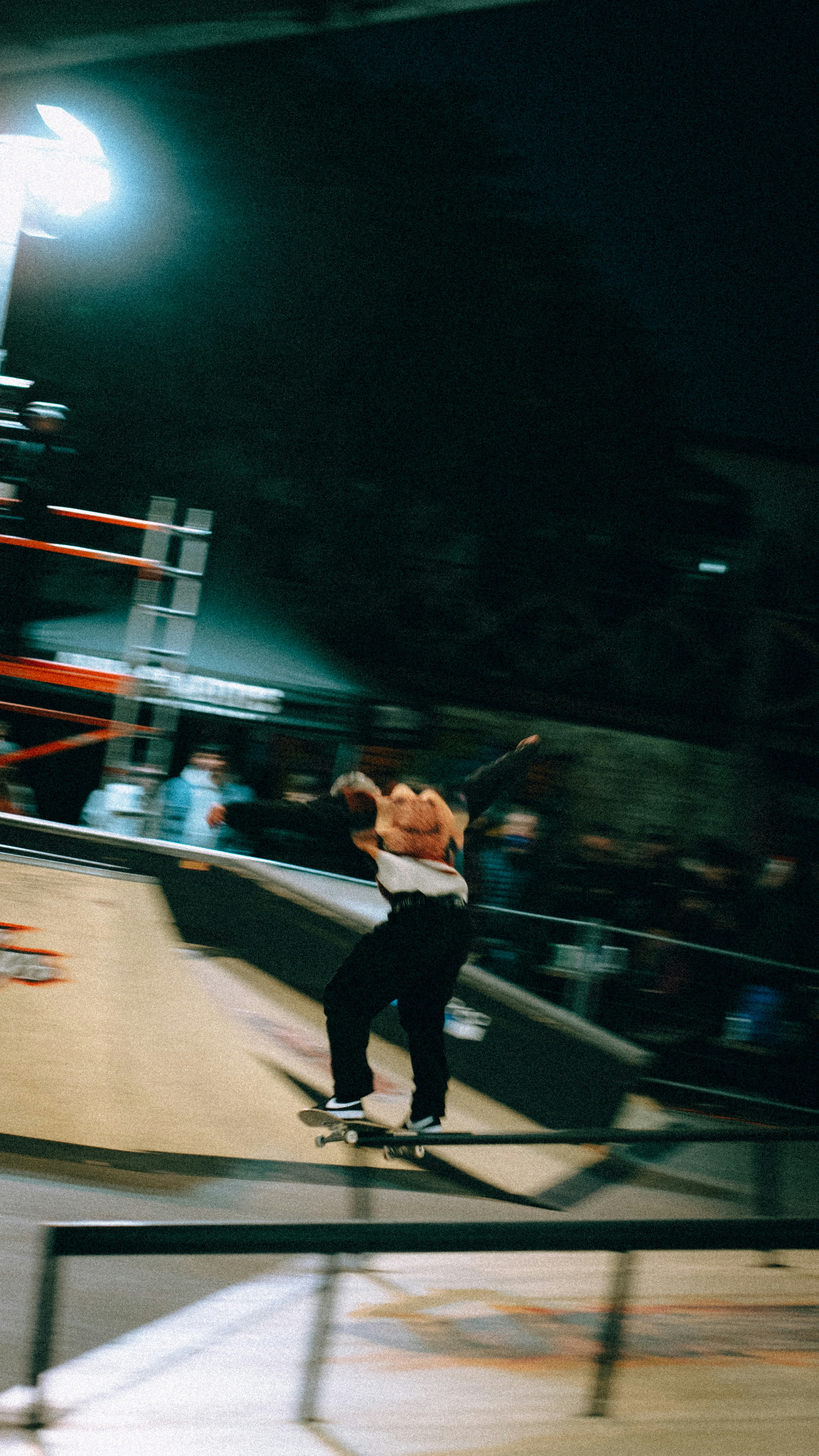 A man riding a skateboard down the side of a ramp