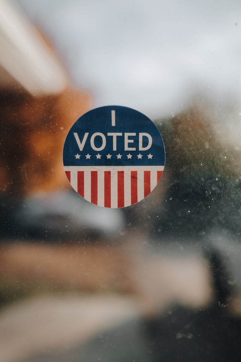 I Voted sticker with American flag design on a window
