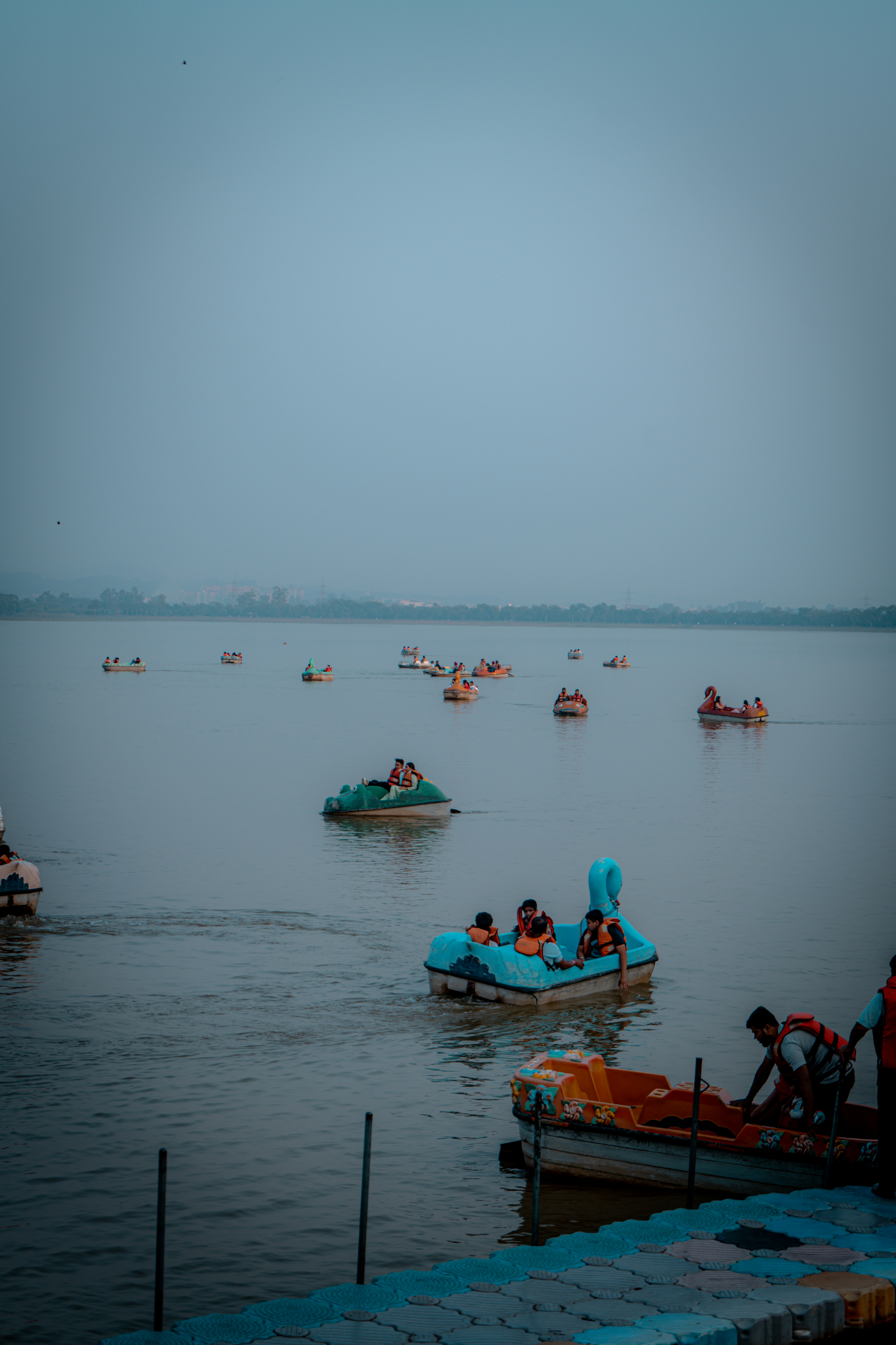A body of water filled with lots of small boats