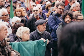 A crowd of people standing around each other