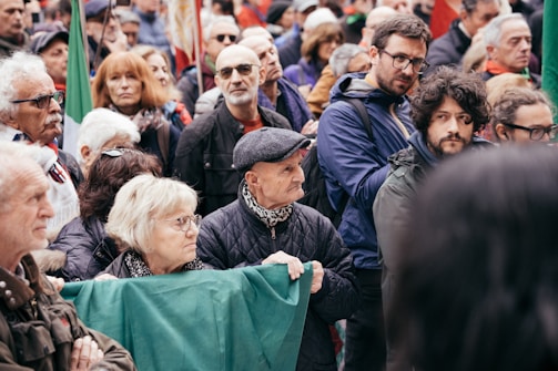 A crowd of people standing around each other