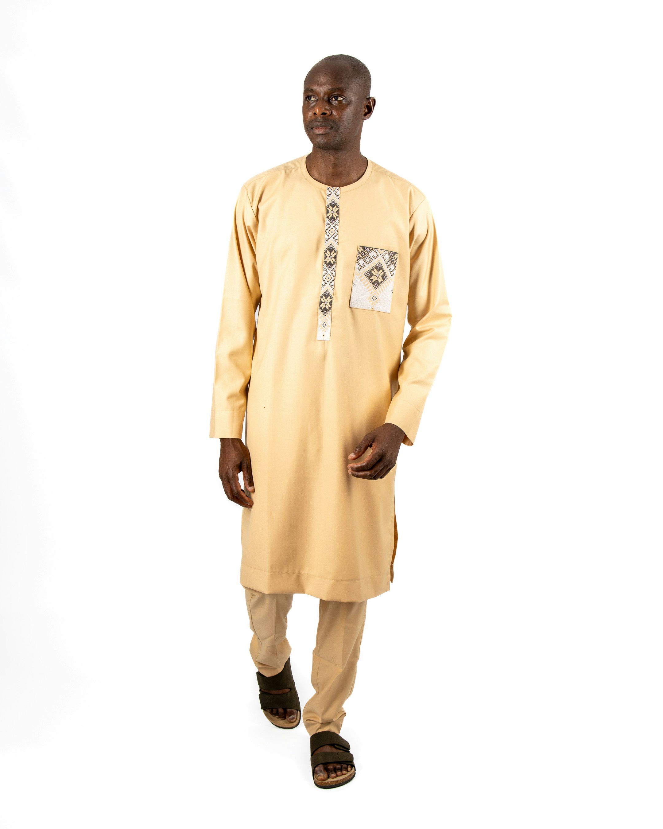 A man in a yellow shirt and tan pants