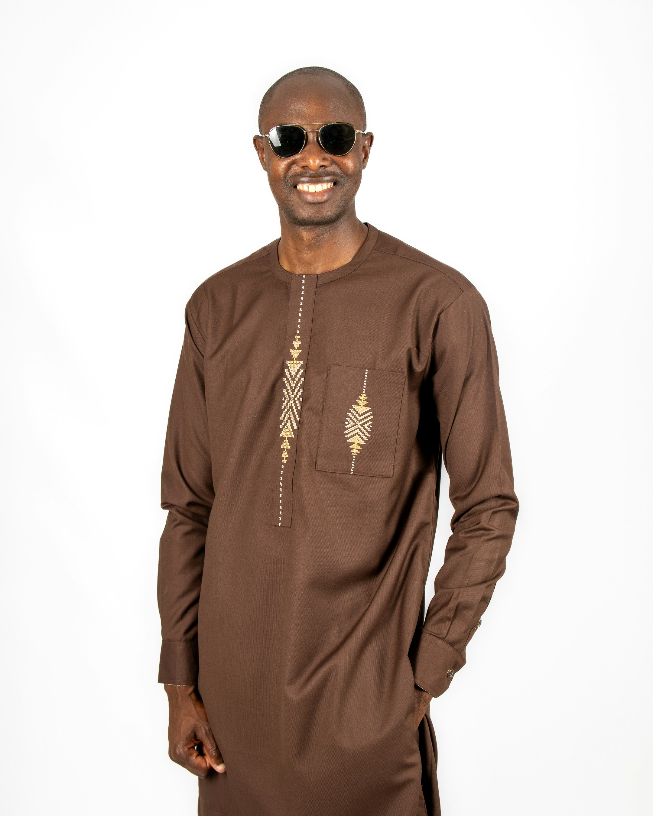 A man in a brown outfit and sunglasses