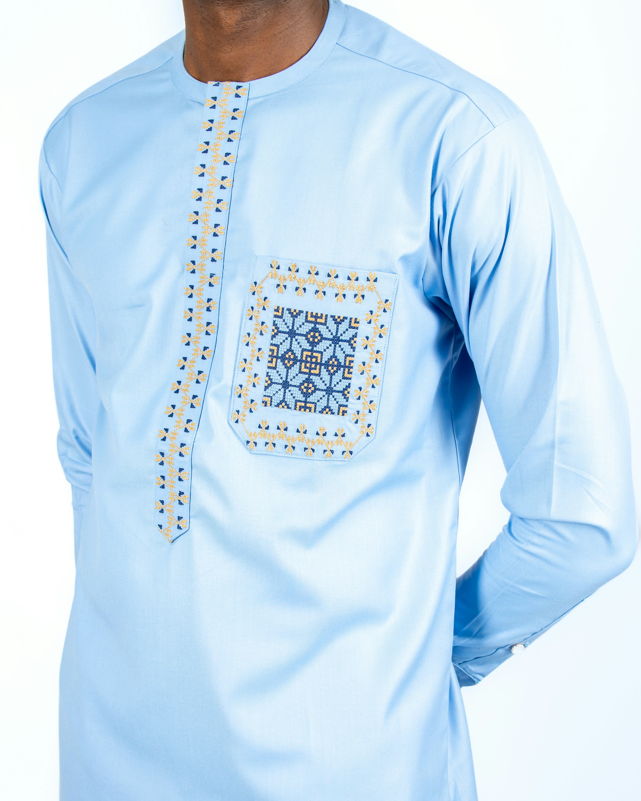 A man wearing a blue shirt with a pattern on it