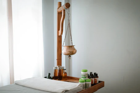 A wooden shelf with bottles and a wooden mannequin on it
