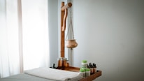 A wooden shelf with bottles and a wooden mannequin on it