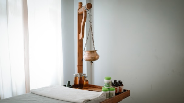 A wooden shelf with bottles and a wooden mannequin on it