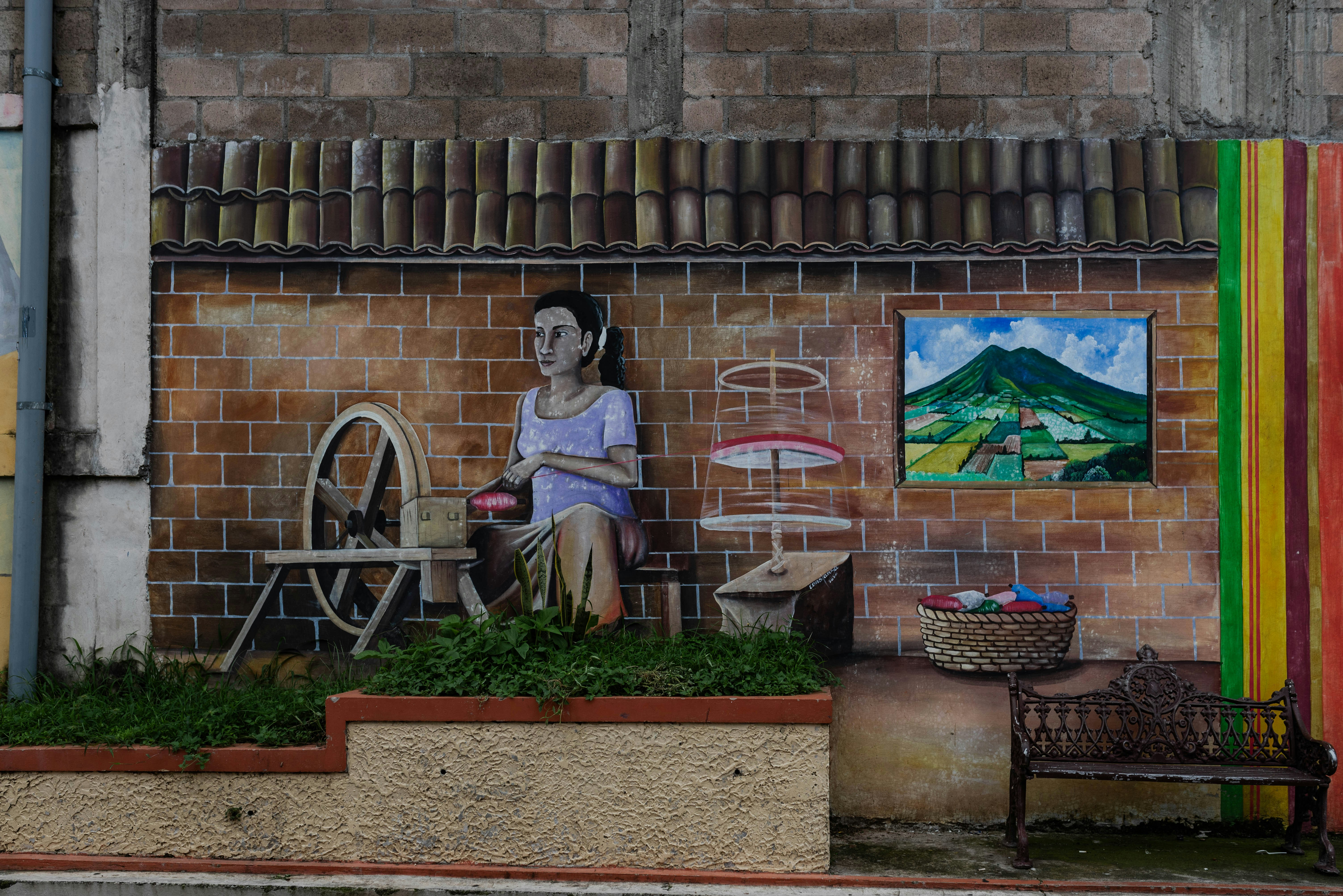 A woman sitting on a bench in front of a building