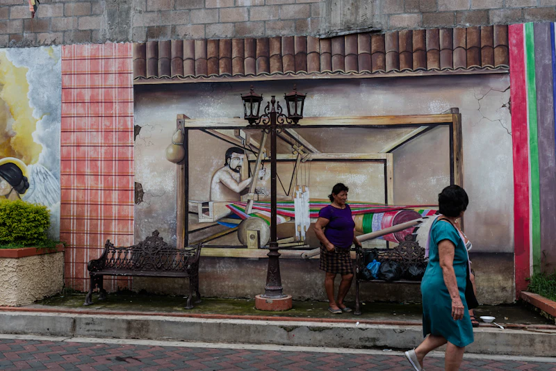 A woman walks past a painted mural
