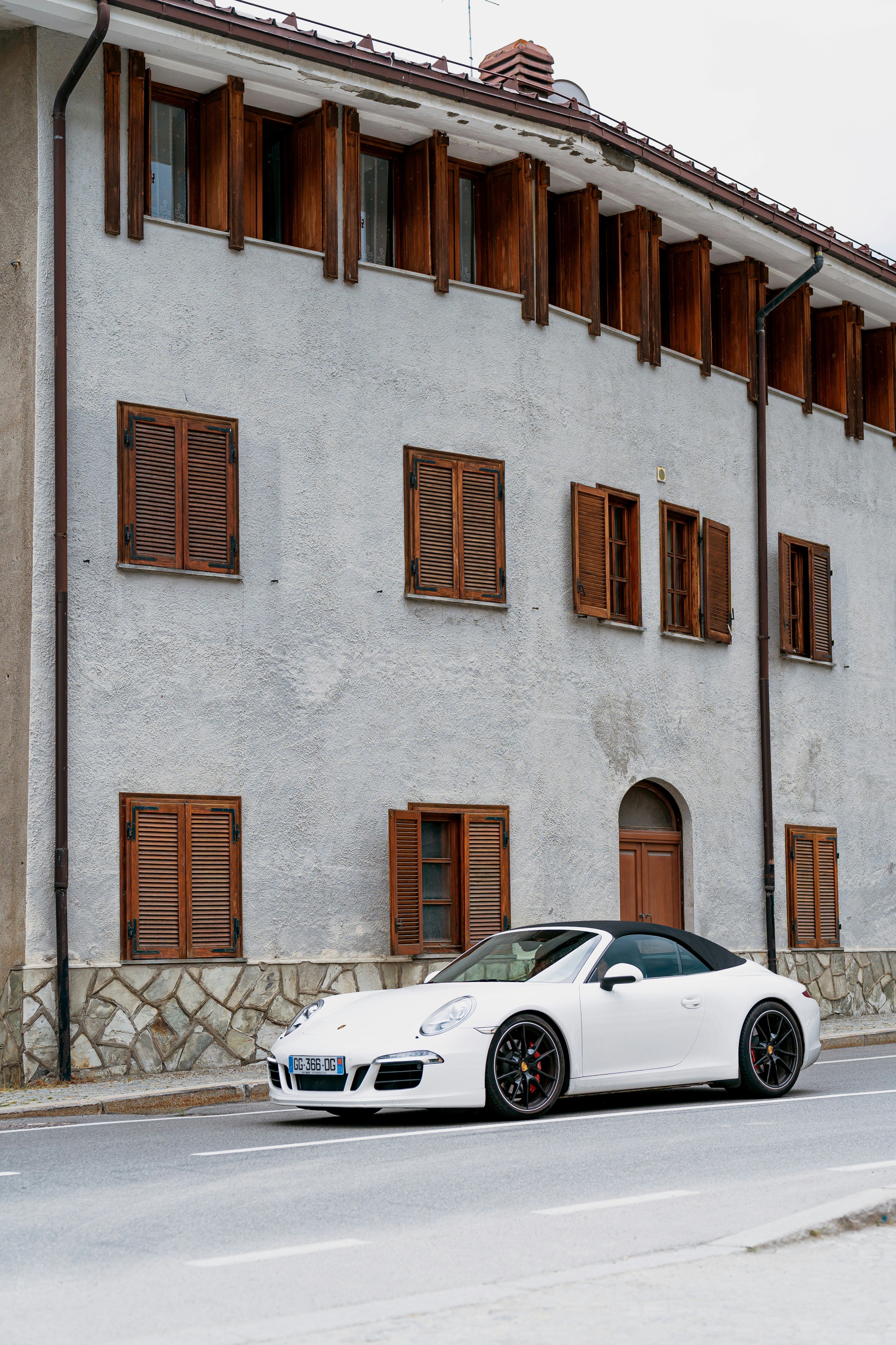 A white car parked in front of a building
