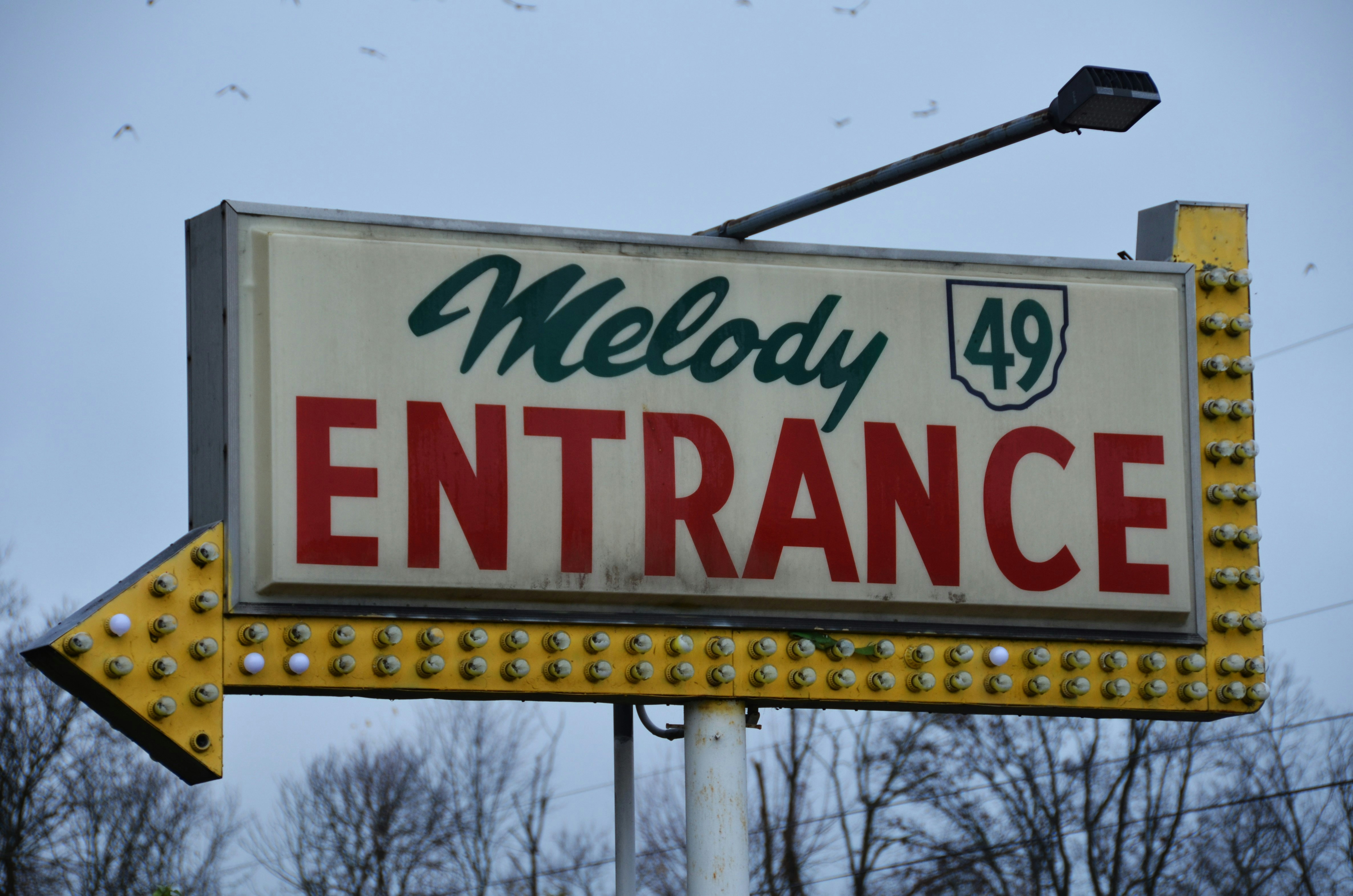 A sign for a business with a arrow pointing to the right