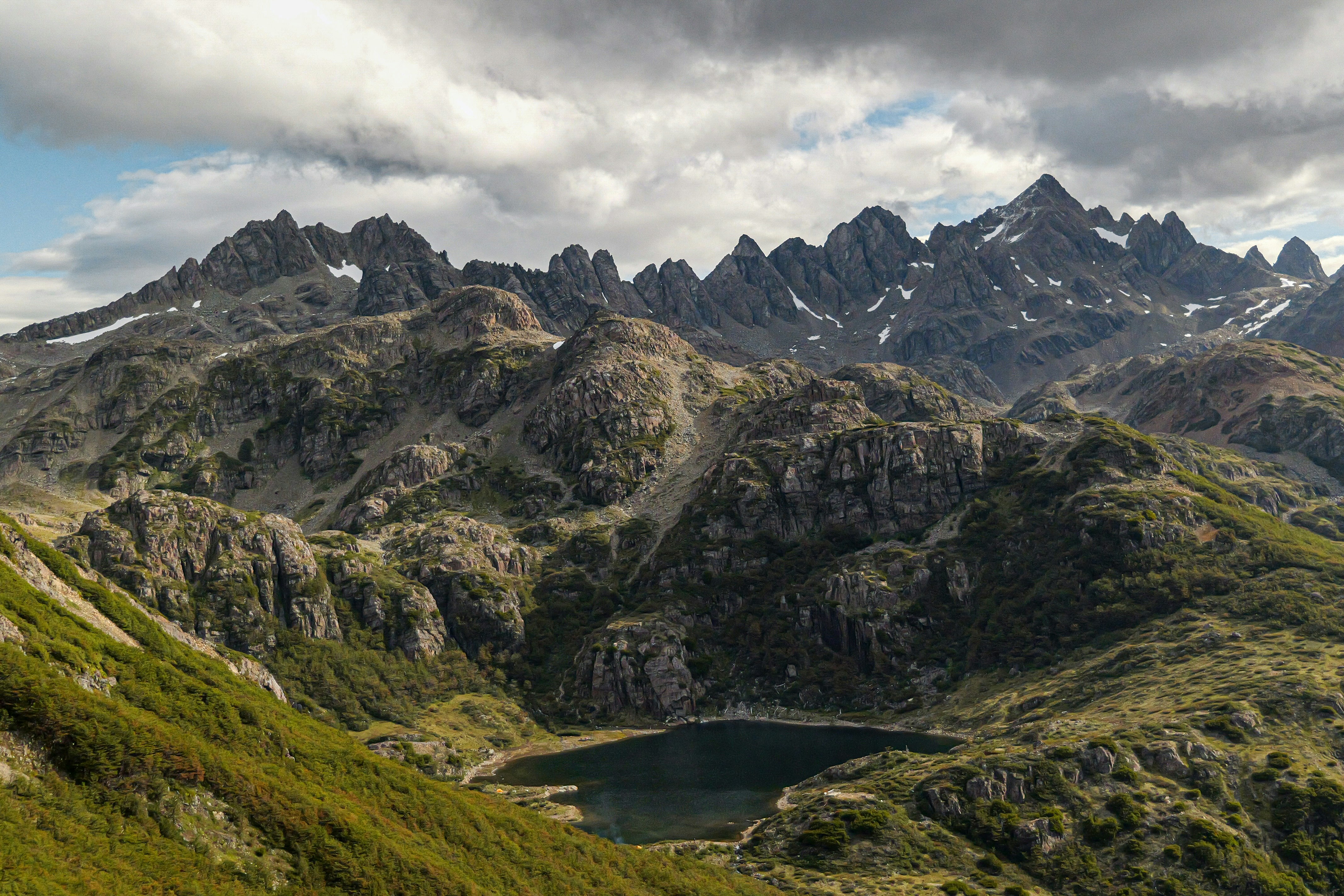 A view of a mountain range with a lake in the foreground