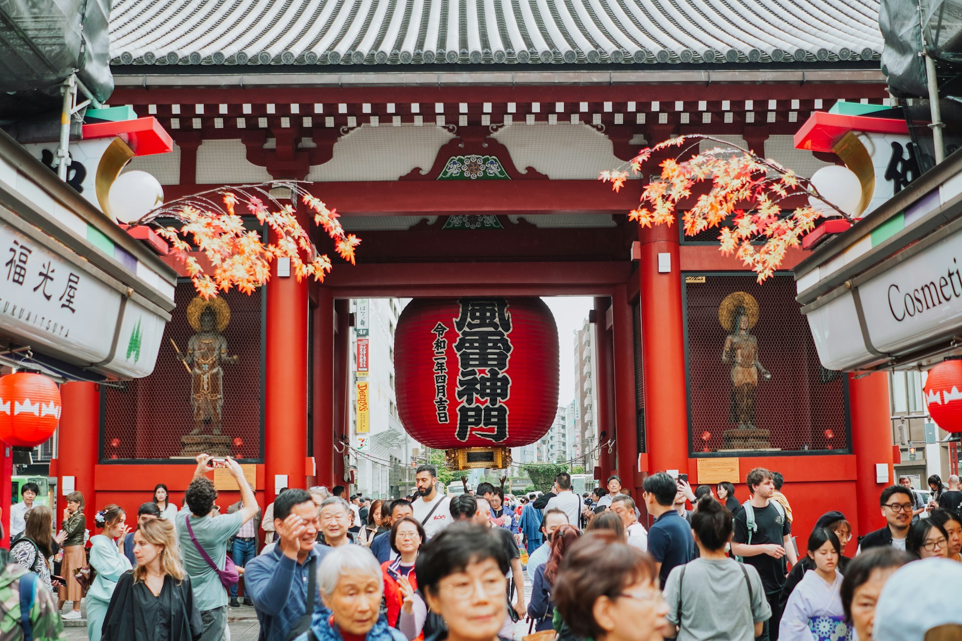 A group of people standing in front of a red building