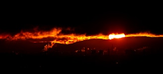 A fire blazing in the sky over a city