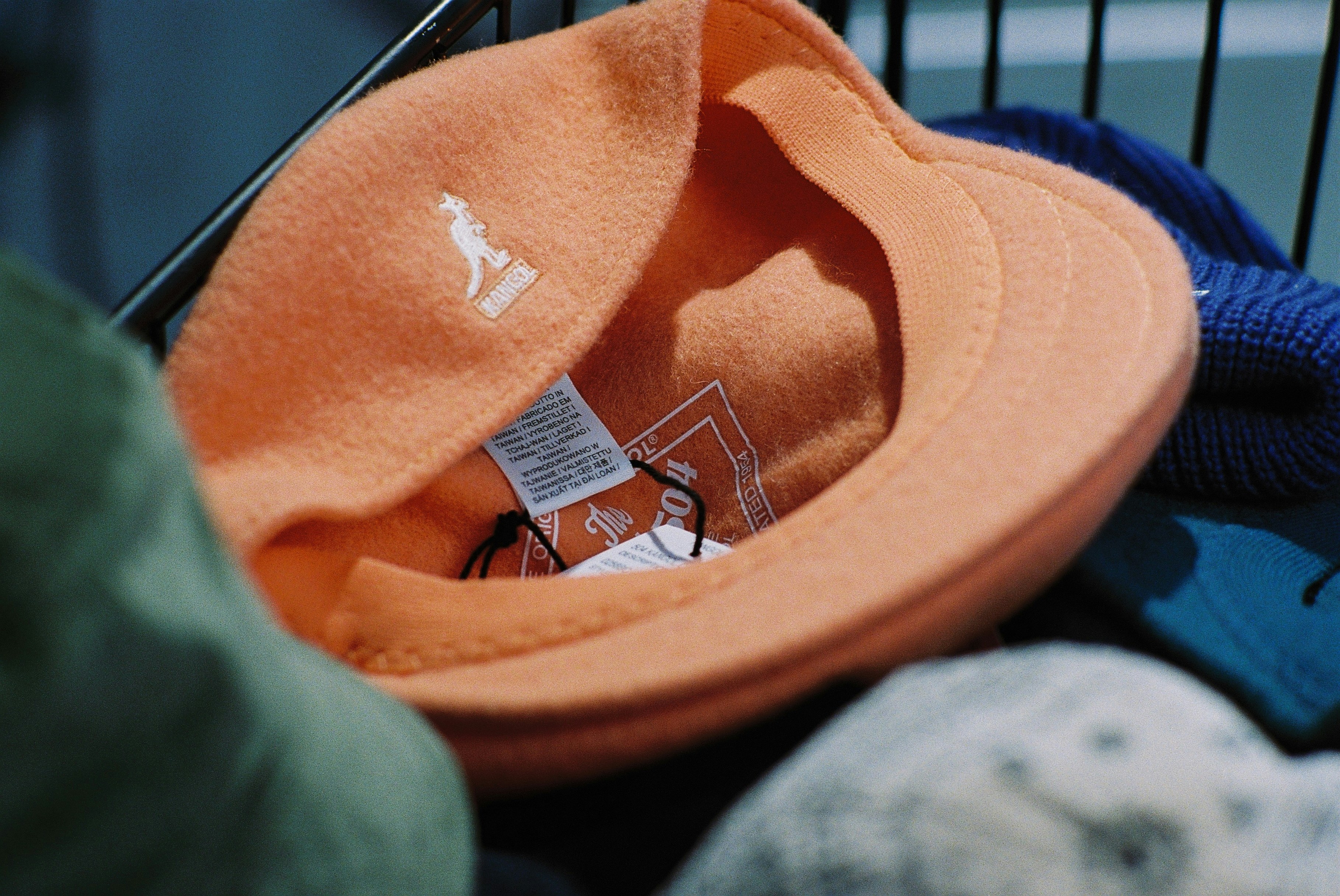 A shopping cart filled with different colored hats