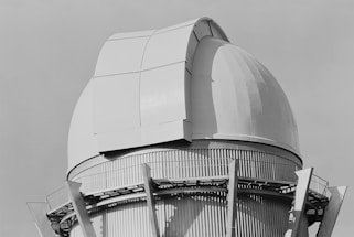 A black and white photo of a large telescope