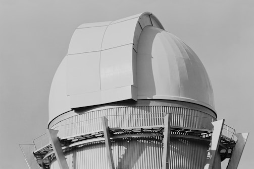 A black and white photo of a large telescope