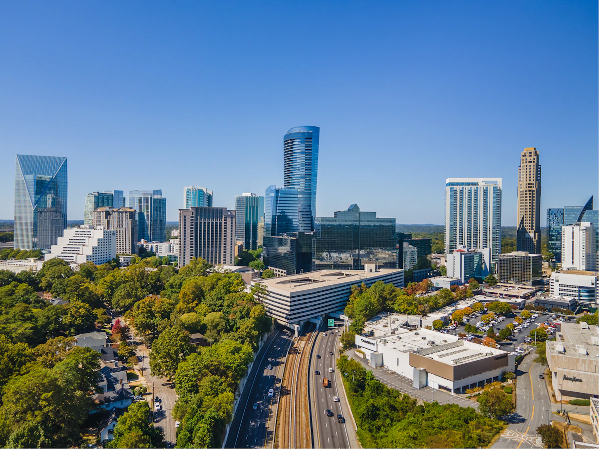 Aerial view of Atlanta cityscape with modern buildings and green tree cover