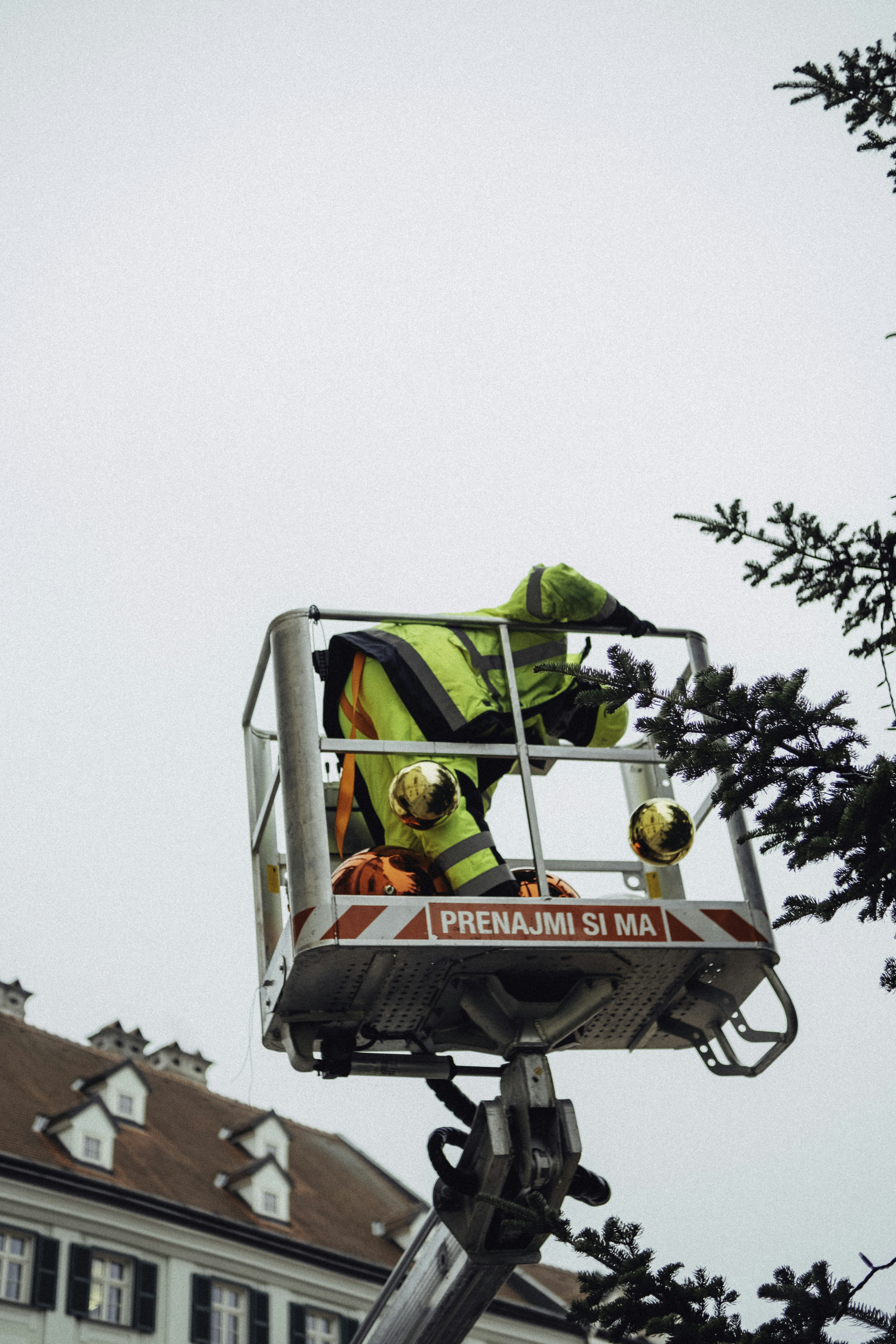 A man on a lift working on a building