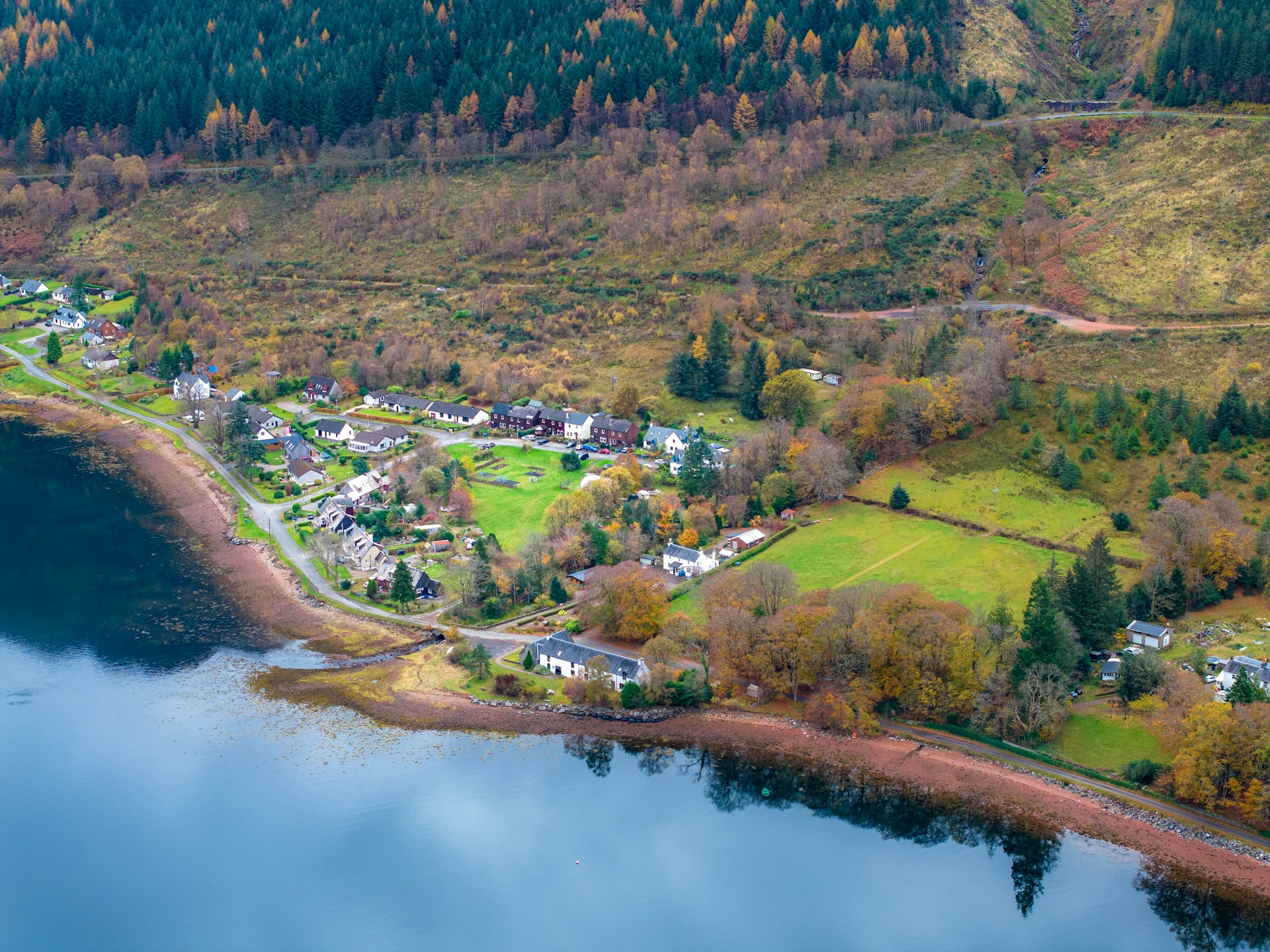 An aerial view of a small town by a lake