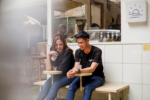 A man and a woman sitting on a bench