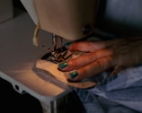A woman using a sewing machine to sew clothes
