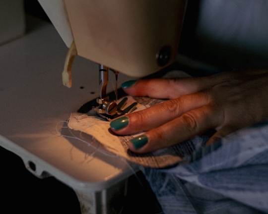 A woman using a sewing machine to sew clothes