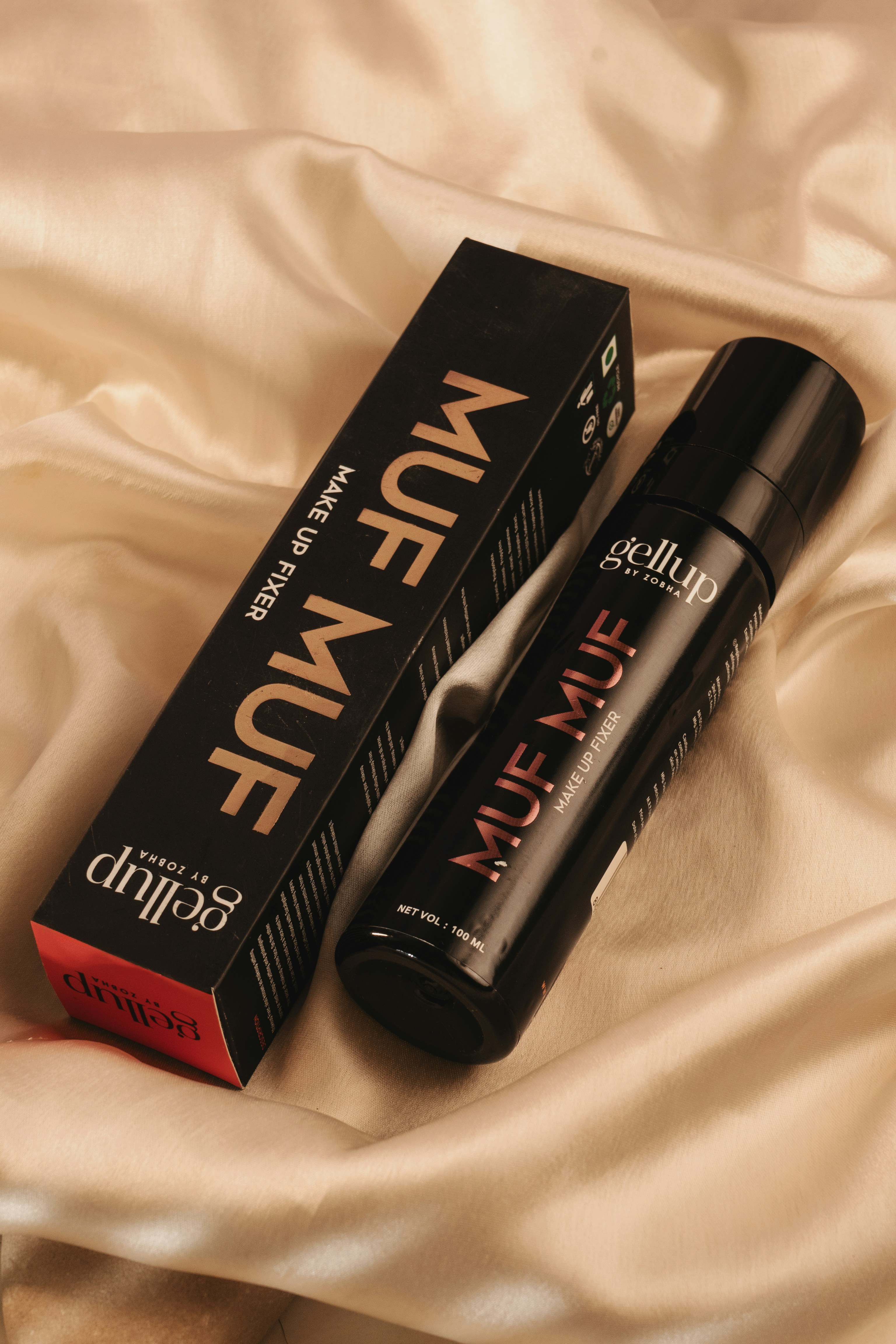 A pair of mascaras sitting on top of a bed