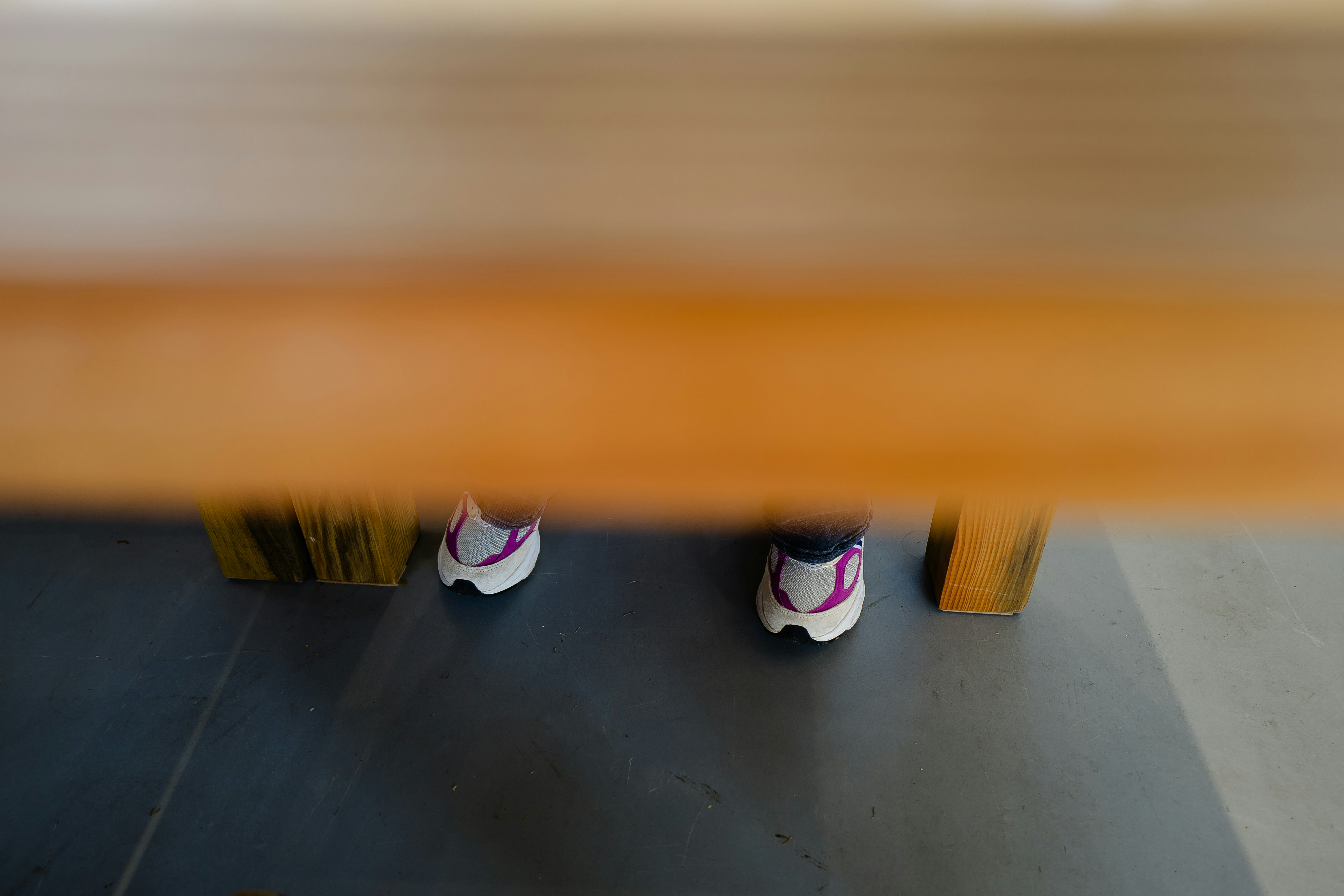 A pair of shoes sitting on top of a wooden bench