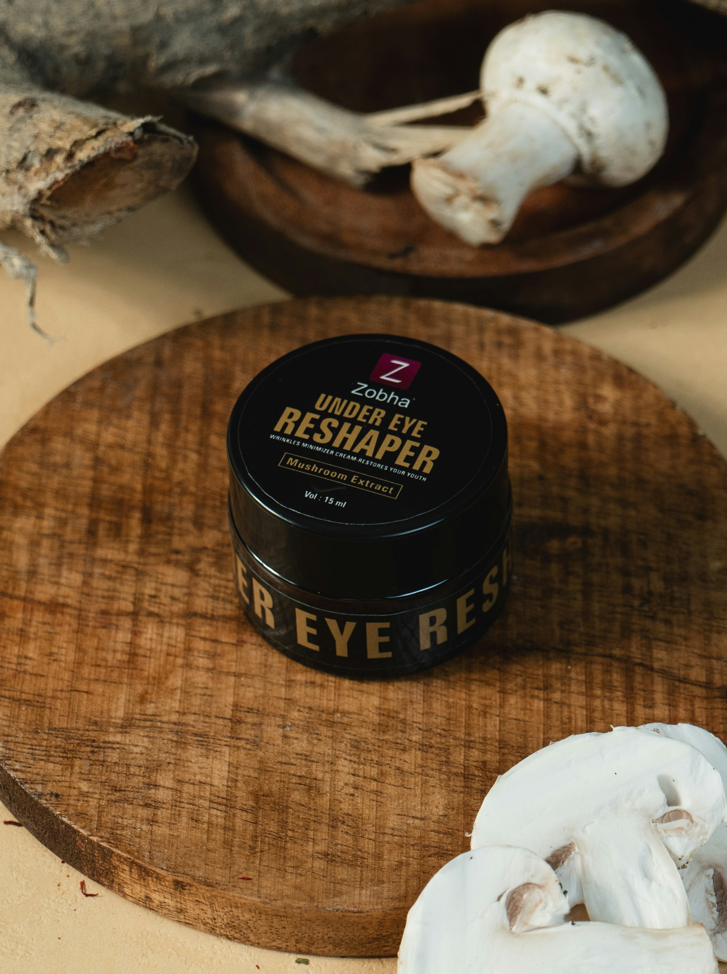 A wooden cutting board topped with a jar of cream