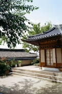 A small building with a tree in front of it