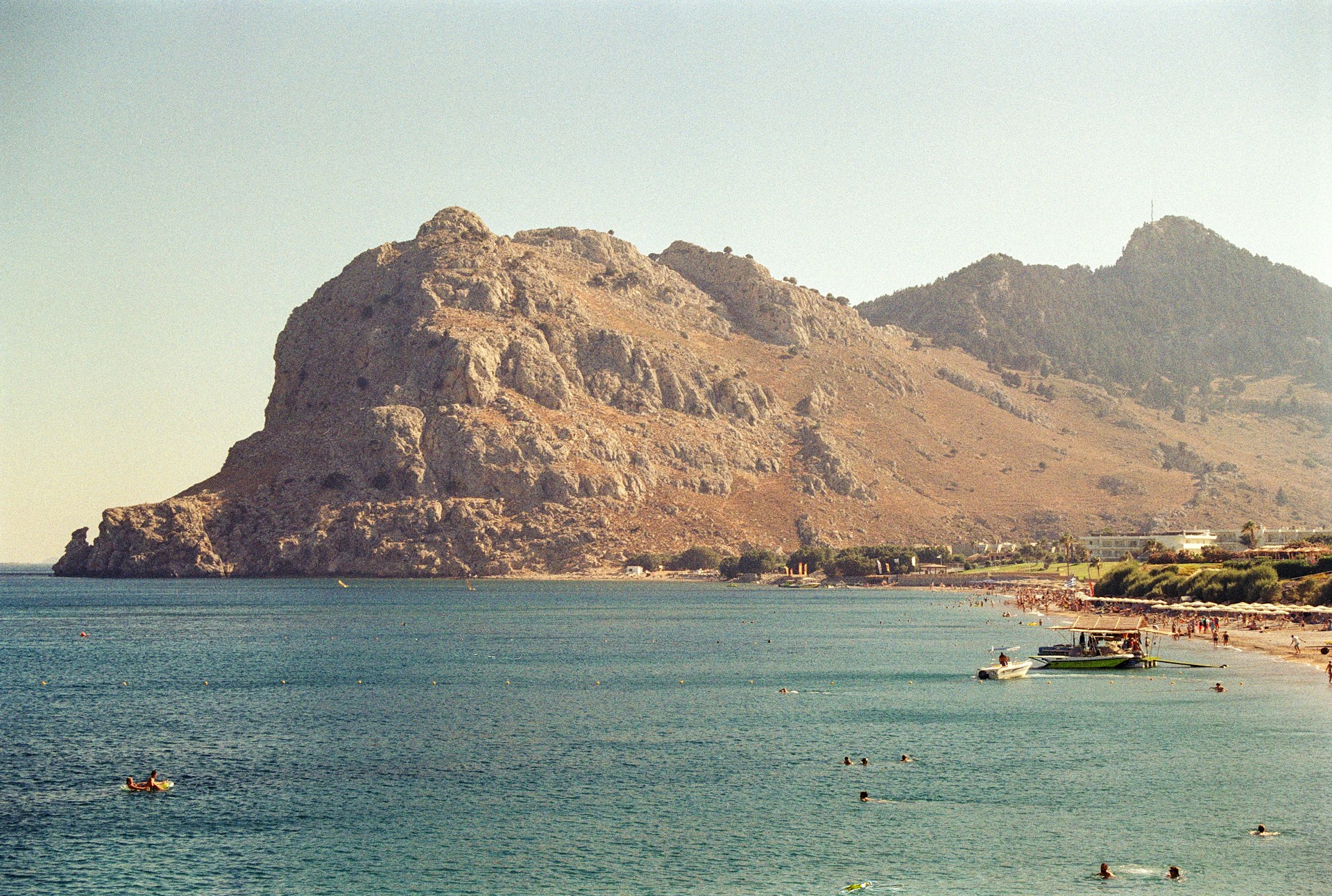 A large body of water with a mountain in the background