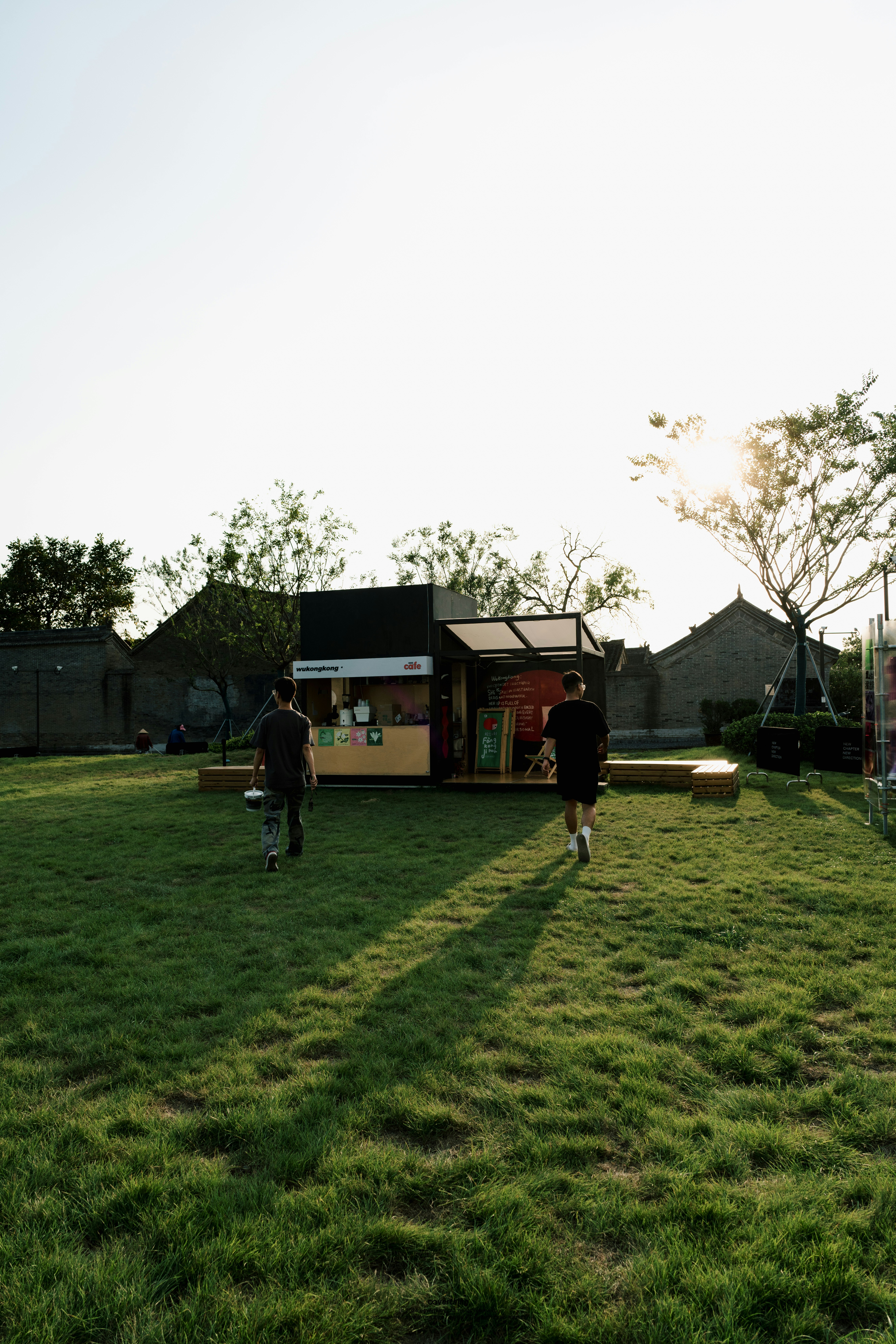 A group of people standing on top of a lush green field