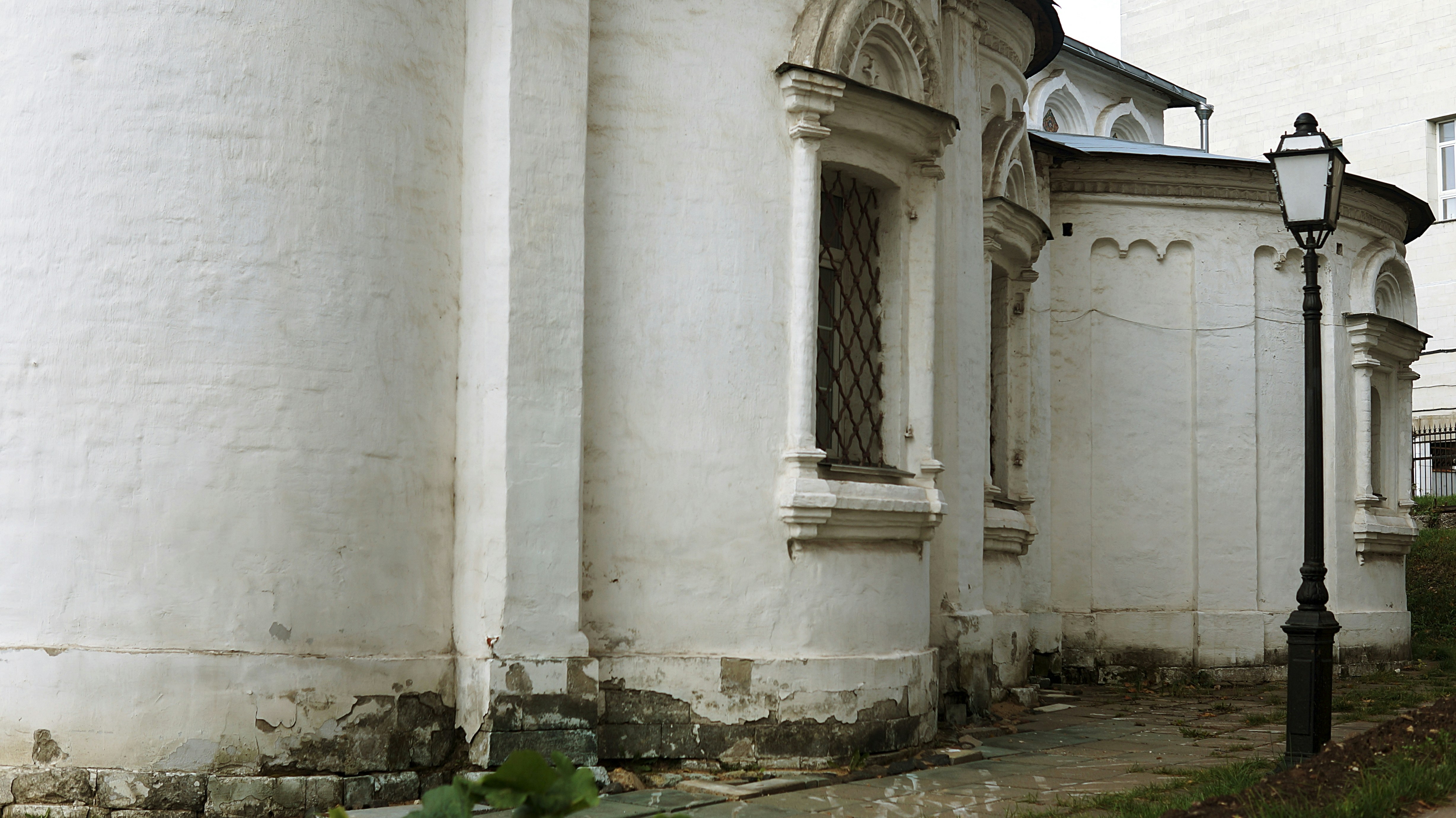 A white building with a clock on the side of it