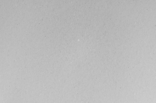 A black and white photo of a plane flying in the sky