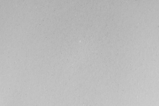 A black and white photo of a plane flying in the sky