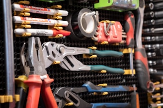 A bunch of tools are hanging on a rack