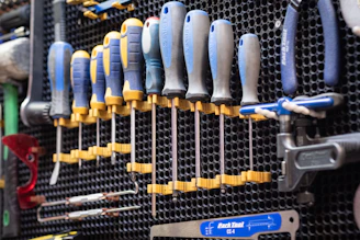 A bunch of tools hanging on a wall