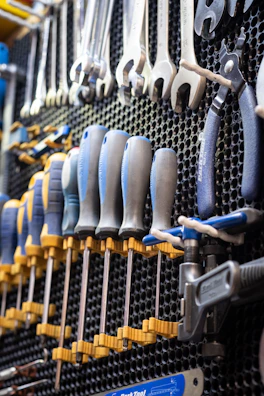 A bunch of tools hanging on a wall