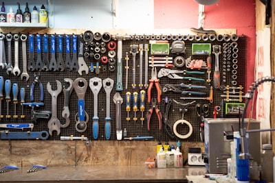 A bunch of tools hanging up on a wall